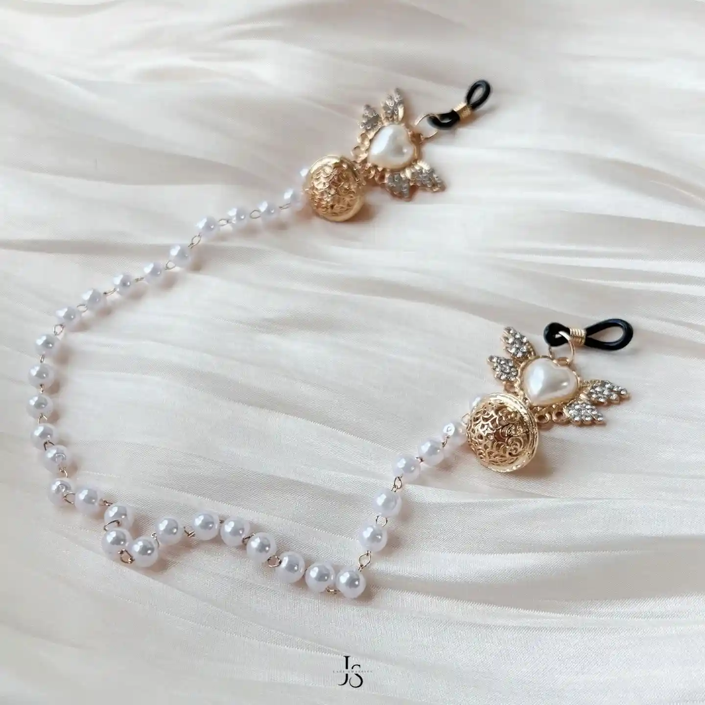 "Stellar Nipple Heart Bell Noose: A pair of heart-shaped nooses with bells and a pearl-inspired connecting chain, available in gold and silver."