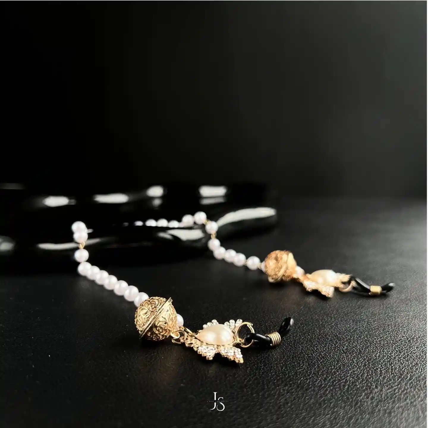 "Stellar Nipple Heart Bell Noose: A pair of heart-shaped nooses with bells and a pearl-inspired connecting chain, available in gold and silver."