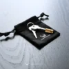 metal key of the chastity cage on a cc black bag