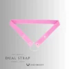 Pink chastity device strap with silver metal ring and snap closures for secure attachment.