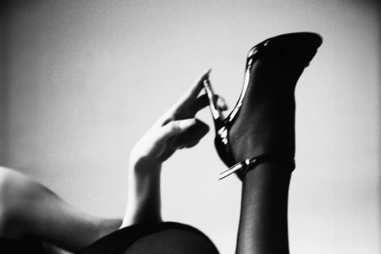 finger point at the end of a leather high heel