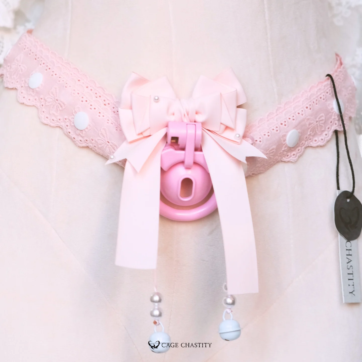 the pink bowtie on the cage with lace strap attached