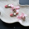 the pink clamp with pink bow and jingle bell