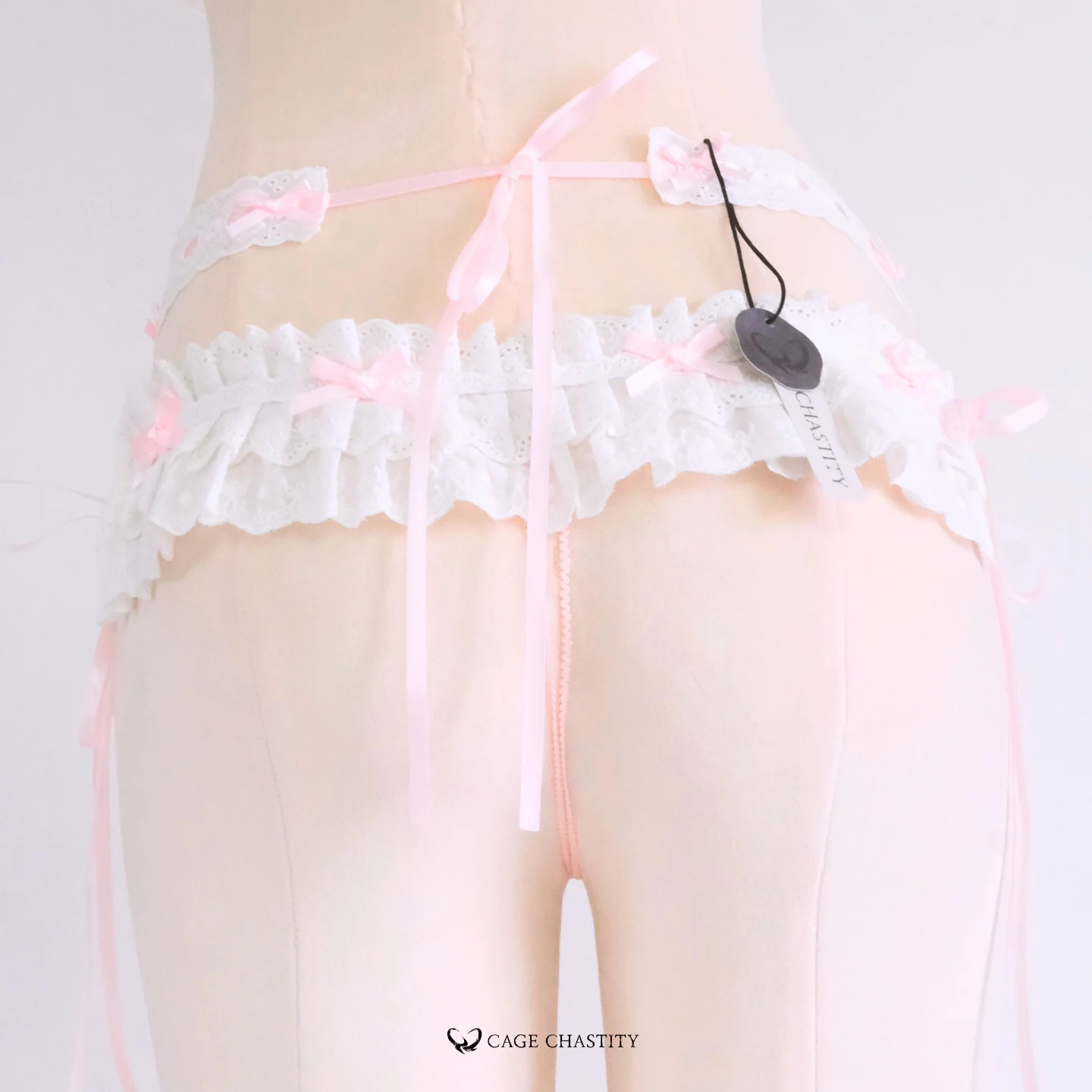 Rear view with tied pink ribbon securing the belt