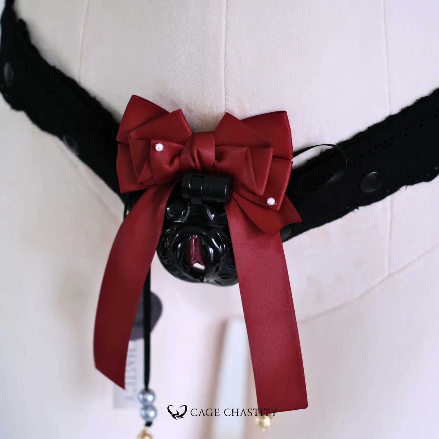 the red bow tie on the black cage