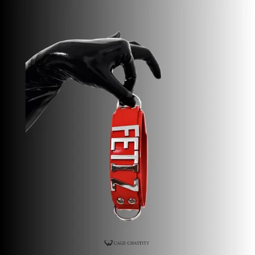 a hand in black silicone glove holding the red collar