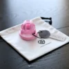 the pink cage with cc tag on a white cc bag