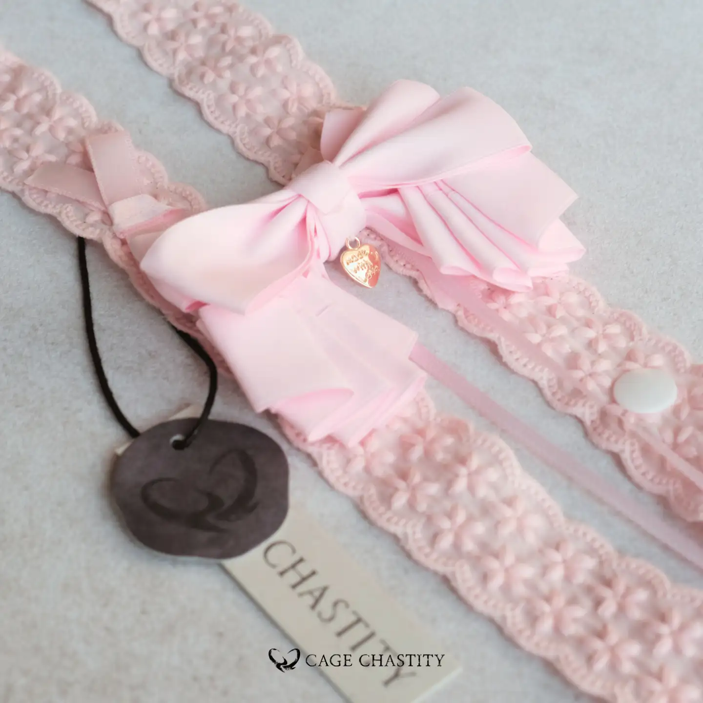 the pink bow tie with a small gold heart