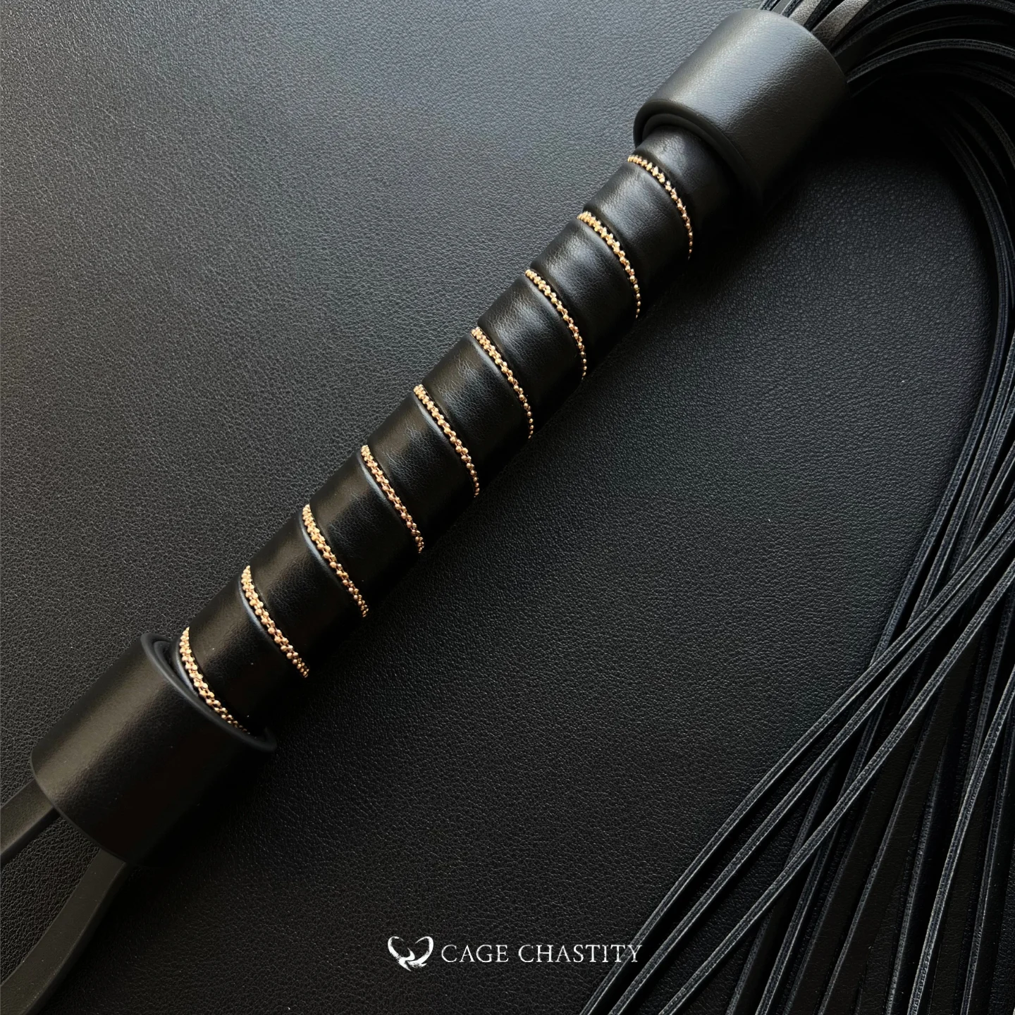 the black whip on the black background surface