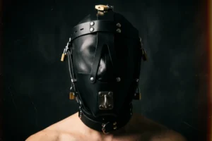 person wearing a fully enclosed leather bondage hood