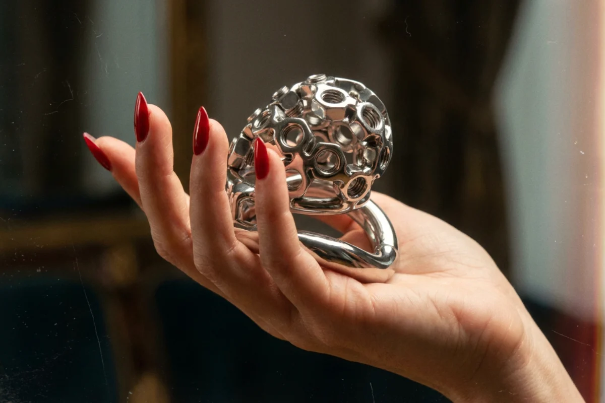 hand holding an extreme CBT chastity cage